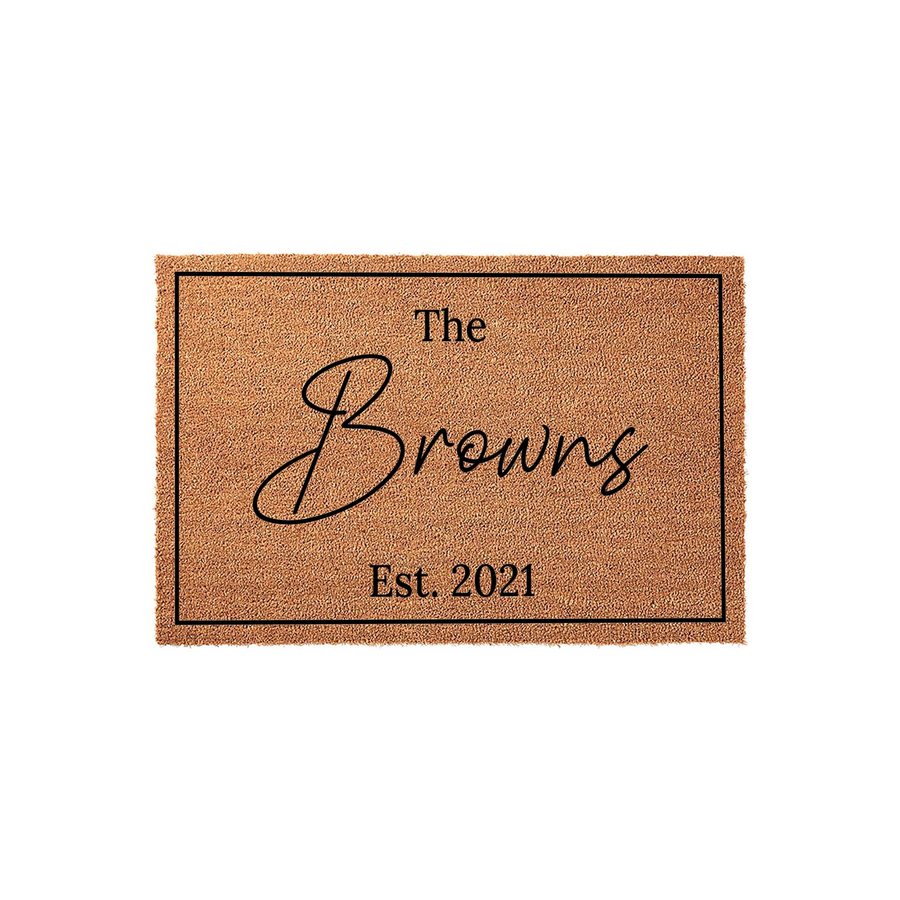 Personalized family name coir doormat featuring a classic rectangular border, elegant script lettering for the last name, and the established year printed in a clean serif font on a natural tan fiber background for a front porch.