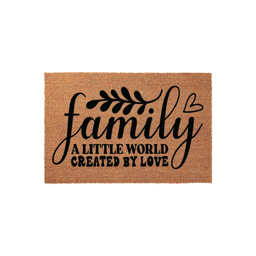 Family A Little World Created By Love coir doormat featuring bold black script lettering and a small heart icon, set against a natural tan textured fiber background for a warm and welcoming entryway decor piece for any modern
