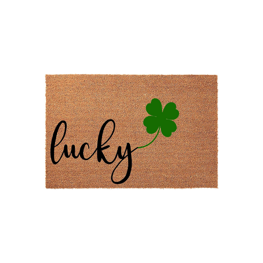 Lucky St. Patrick's Day coir doormat featuring the word lucky in elegant black script lettering next to a vibrant green four-leaf clover, set against a natural brown textured fiber background for a festive front porch entrance.