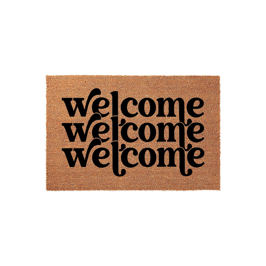 Welcome coir doormat featuring a modern layered typography design with the word welcome printed three times in bold black ink against a natural tan textured fiber background, creating a stylish entryway decor piece for your front