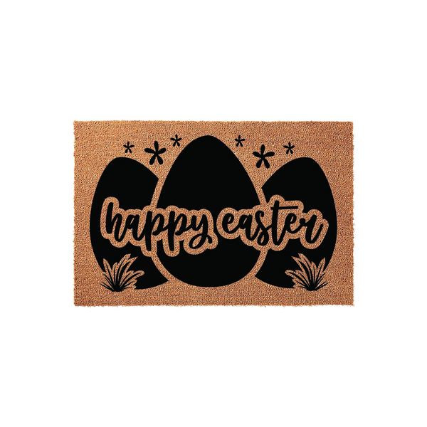 Happy Easter coir doormat featuring a trio of large black egg silhouettes decorated with small flowers and grass accents, set against a natural brown textured fiber background for a festive spring entryway decor display.