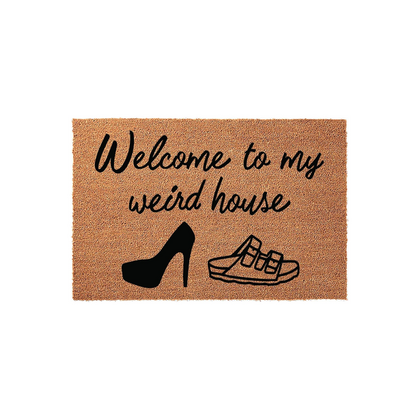Welcome to my weird house coir doormat featuring black text and illustrations of a high heel shoe and a sandal, set against a natural brown fiber background to add a humorous and welcoming touch to your front porch entryway decor.