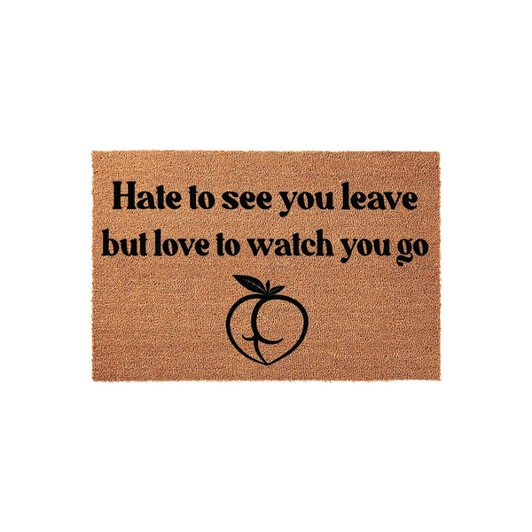 Funny doormat with the text Hate to see you leave but love to watch you go printed in black ink above a stylized peach icon, featuring a natural coir fiber texture on a plain white background for a humorous front porch entryway