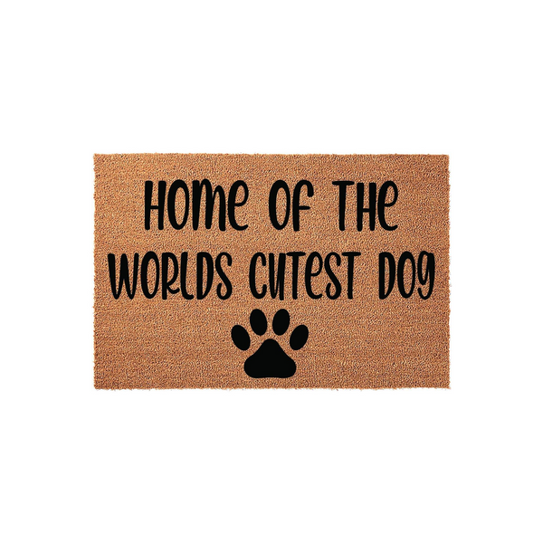 Home of the Worlds Cutest Dog coir doormat featuring a natural tan fiber texture and bold black lettering that reads Home of the Worlds Cutest Dog, accented by a simple black paw print icon centered at the bottom of the