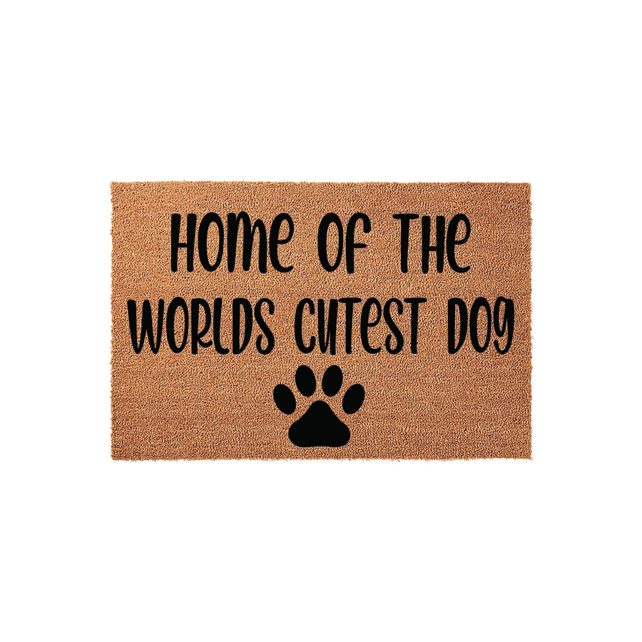 Home of the Worlds Cutest Dog coir doormat featuring a natural tan fiber texture and bold black lettering that reads Home of the Worlds Cutest Dog, accented by a simple black paw print icon centered at the bottom of the