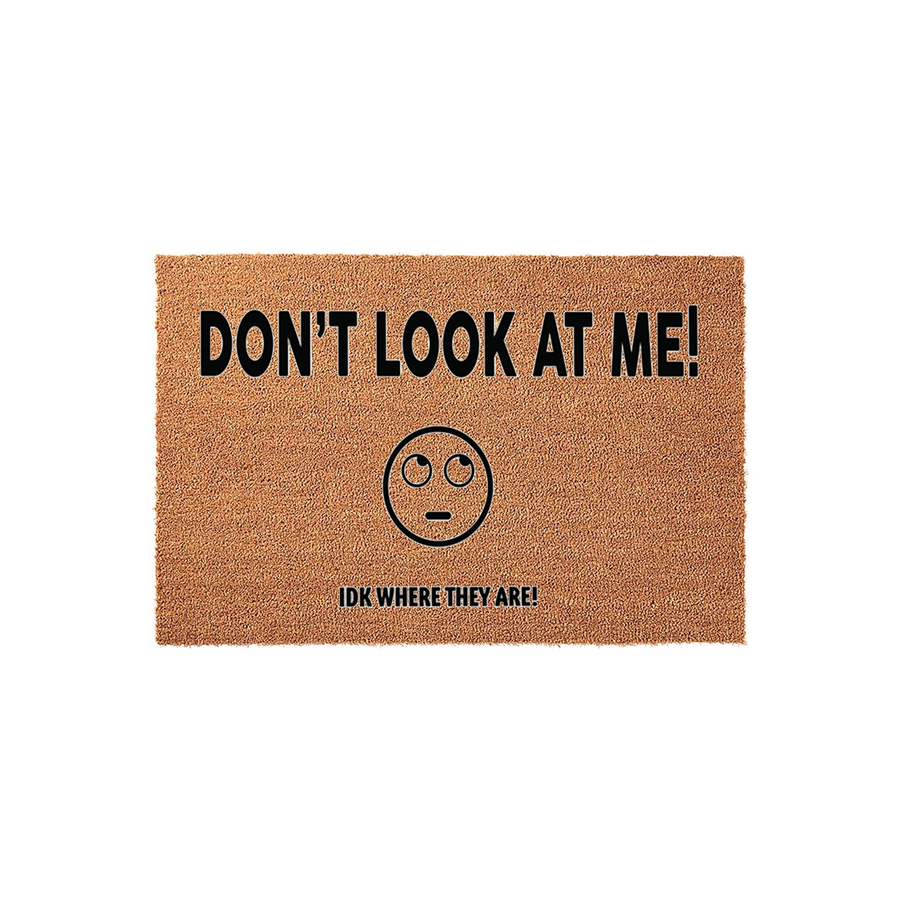 Funny Don't Look At Me doormat made of natural coir fiber, featuring a bold black text design with an eye-rolling emoji face and the phrase IDK WHERE THEY ARE printed on a textured brown background for a humorous front porch