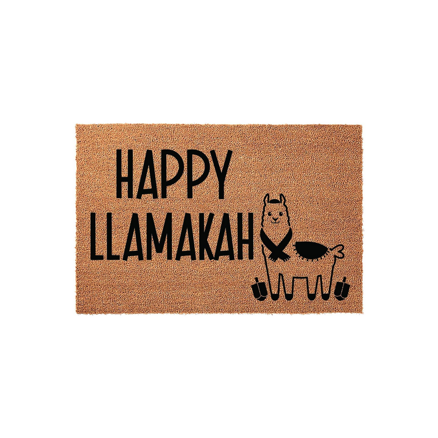 Happy Llamakah coir doormat featuring a cute llama wearing a scarf and a yarmulke, surrounded by dreidels on a natural brown fiber background, making a festive Hanukkah decoration for your front porch or entryway floor.