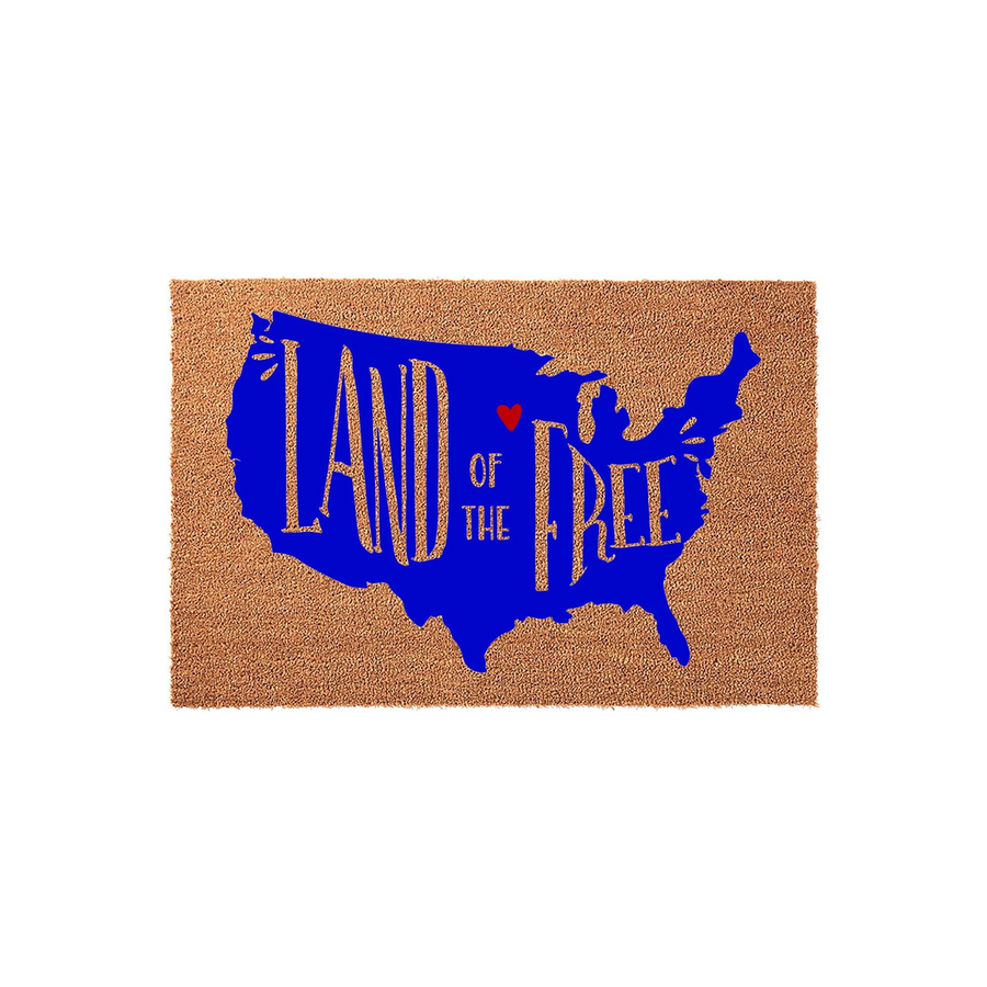 Land of the Free patriotic coir doormat featuring a bold blue map of the United States with gold lettering and a small red heart, providing a festive and welcoming entrance decor piece for your front porch or home entryway.