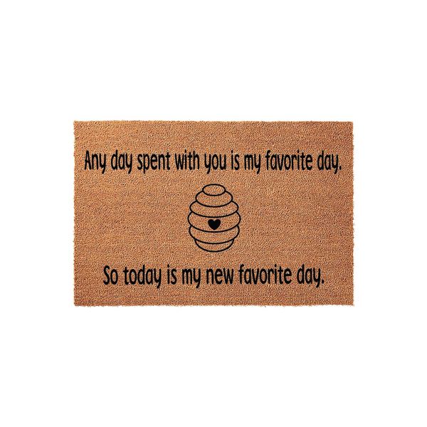 Beehive Welcome Doormat featuring a natural coir texture with black text that reads Any day spent with you is my favorite day, so today is my new favorite day, centered around a simple line-art beehive illustration with a small