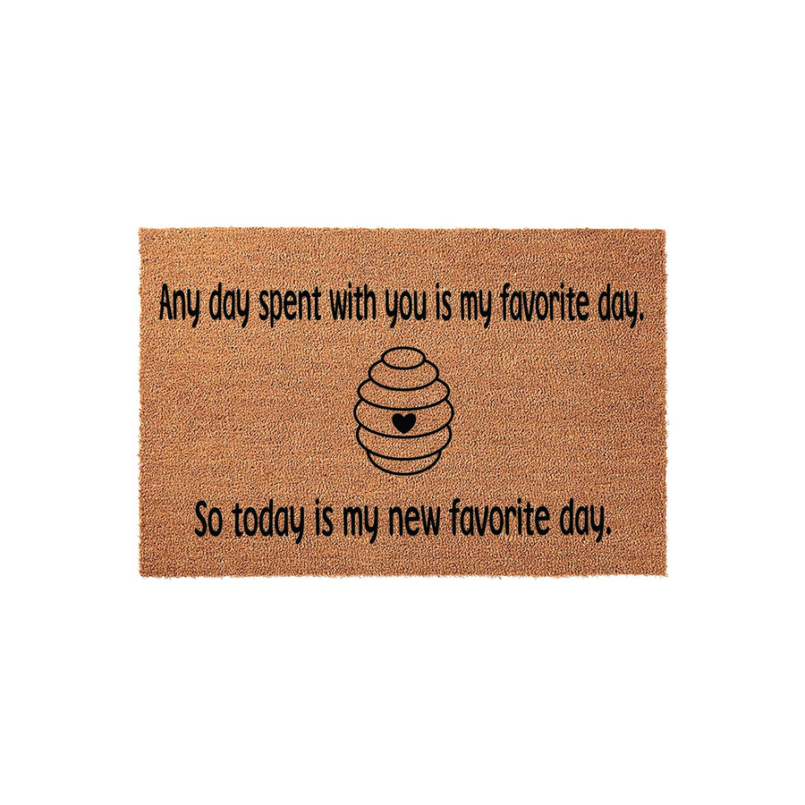 Beehive Welcome Doormat featuring a natural coir texture with black text that reads Any day spent with you is my favorite day, so today is my new favorite day, centered around a simple line-art beehive illustration with a small