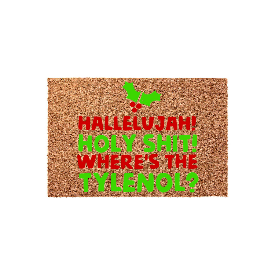 Funny Christmas doormat featuring a natural coir texture with bold red and green text that reads Hallelujah! Holy Shit! Where's the Tylenol? accented by a festive holly leaf and berry graphic on a clean, plain white studio