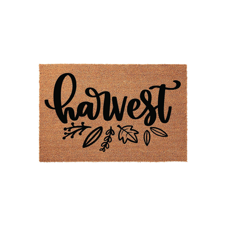 Harvest Fall Coir Doormat featuring a natural brown fiber texture with the word harvest written in a bold black script font, accented by simple hand-drawn leaf and berry illustrations for a festive autumn entryway decor style.