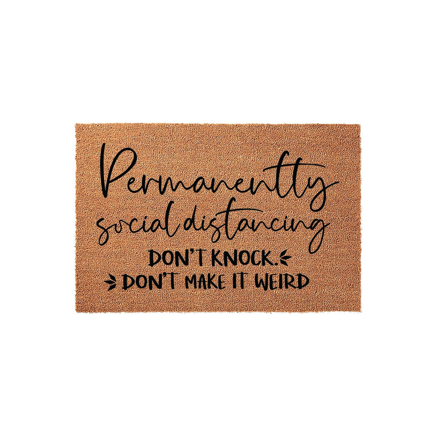 Funny Permanently Social Distancing doormat made of natural coir fibers, featuring bold black text that reads Don't Knock and Don't Make It Weird, creating a humorous and welcoming entrance decor piece for your front porch or