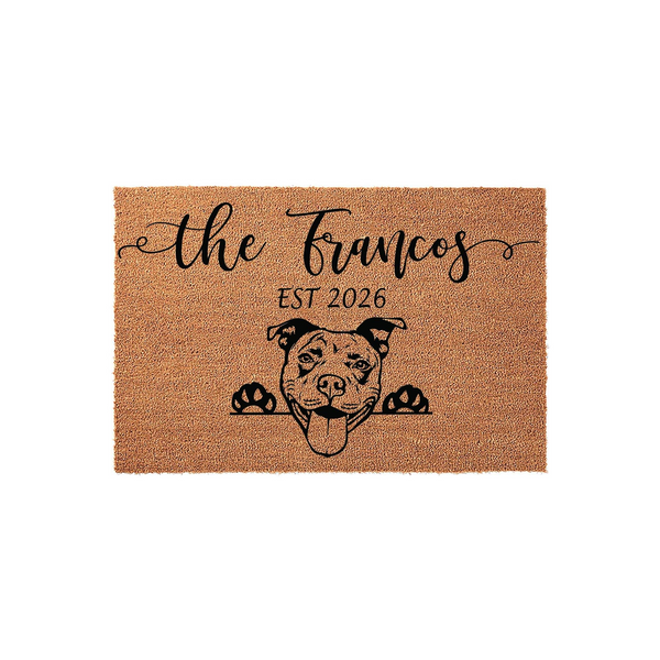 Personalized Pit Bull doormat featuring a natural coir texture with a black printed illustration of a happy Pit Bull dog peeking over the edge, customized with a family name and established year on a clean white studio background.