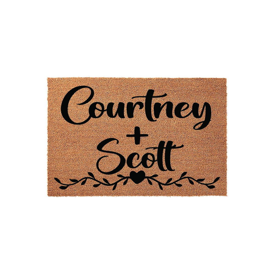 Personalized couple doormat featuring a natural coir texture with black script lettering and a decorative vine and heart design, providing a welcoming touch for a front porch entrance while showcasing a custom name design for new