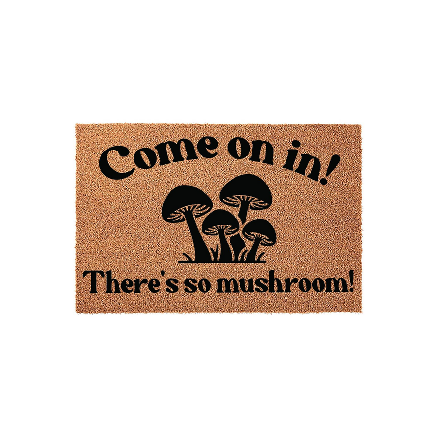 Mushroom themed coir doormat featuring a playful pun that reads Come on in! There is so mushroom! in bold black lettering, set against a natural tan fiber background for a fun and welcoming entryway decor piece for your home