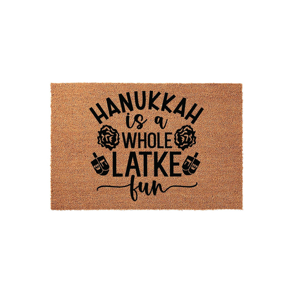 Hanukkah is a Whole Latke Fun coir doormat featuring black printed text and festive dreidel icons on a natural tan fiber background, making a humorous and welcoming addition to your front porch decor for the holiday season.