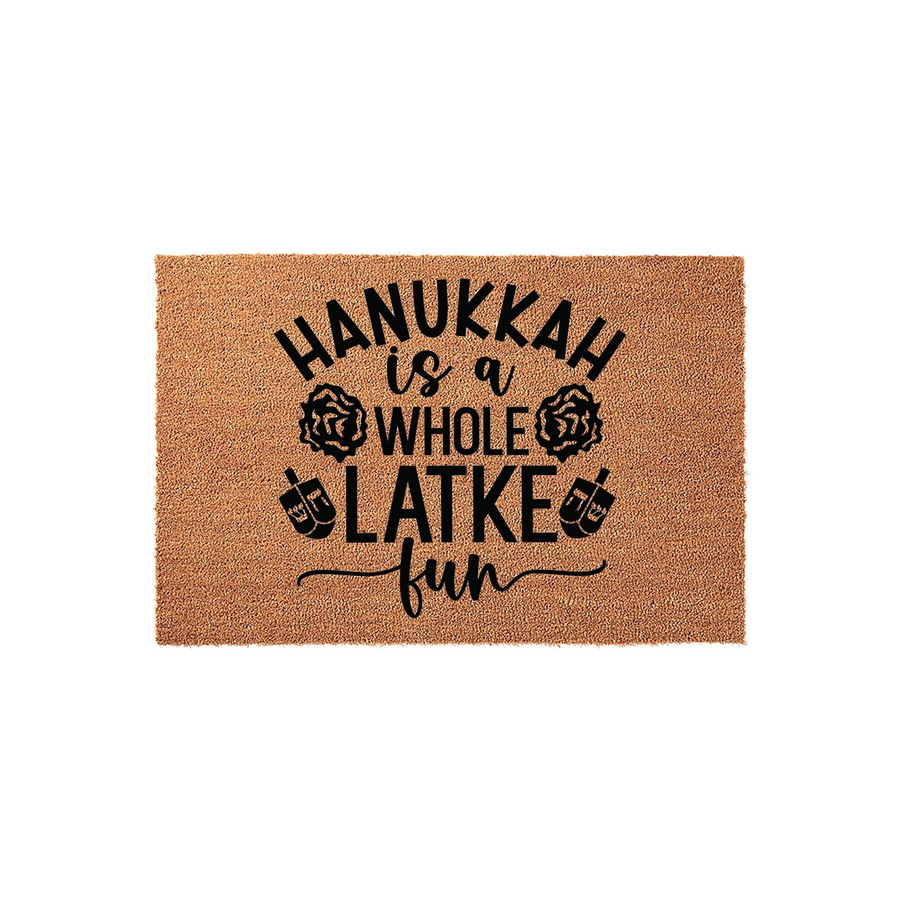 Hanukkah is a Whole Latke Fun coir doormat featuring black printed text and festive dreidel icons on a natural tan fiber background, making a humorous and welcoming addition to your front porch decor for the holiday season.