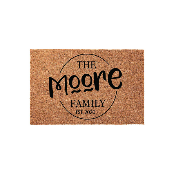 Personalized family name coir doormat featuring a circular design with custom text and an established year, set against a clean white background to showcase the natural tan fiber texture and bold black lettering for a modern home