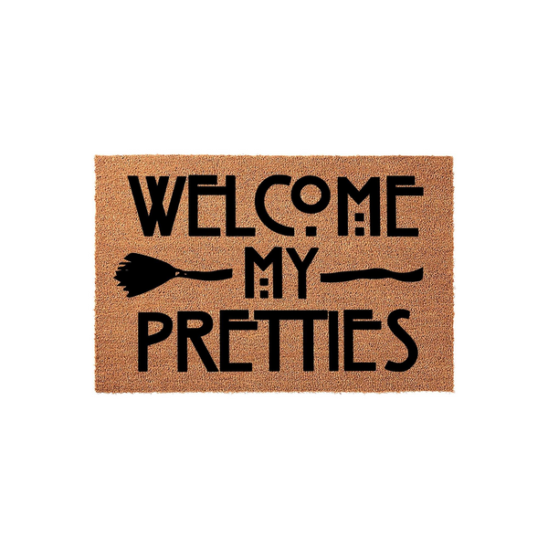 Welcome My Pretties Halloween doormat featuring a natural coir texture and bold black text with a witch broom graphic, creating a festive and spooky entryway decor piece for the fall season on a clean white background.