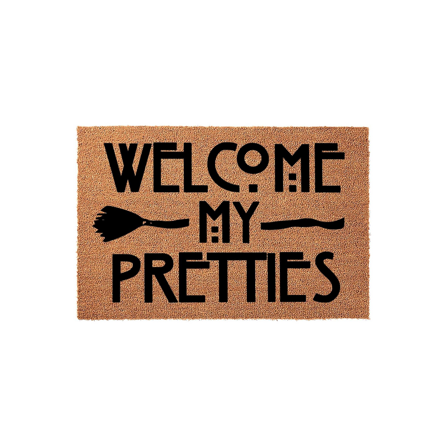 Welcome My Pretties Halloween doormat featuring a natural coir texture and bold black text with a witch broom graphic, creating a festive and spooky entryway decor piece for the fall season on a clean white background.