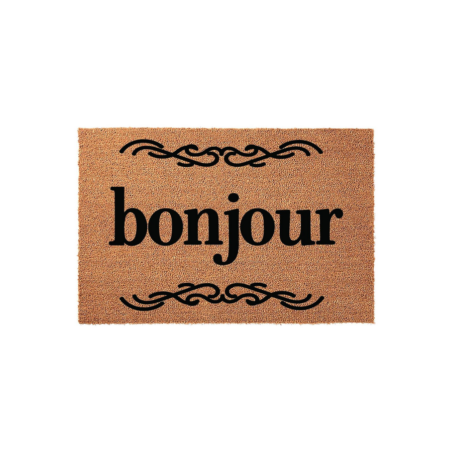 Bonjour coir doormat featuring a natural tan fiber texture with the word bonjour printed in bold black lettering, accented by elegant decorative scrollwork flourishes above and below the text on a clean white studio background.