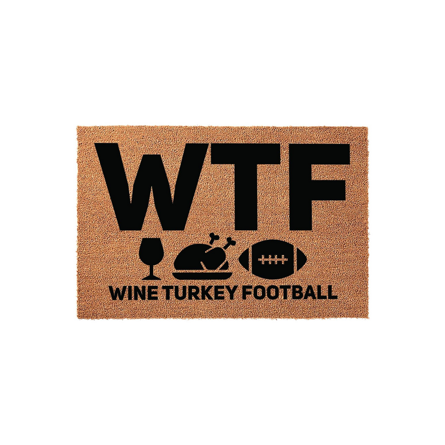 Funny Thanksgiving doormat featuring the text WTF with icons for wine, a roasted turkey, and a football, followed by the words WINE TURKEY FOOTBALL printed in black on a natural brown coir fiber mat against a clean white
