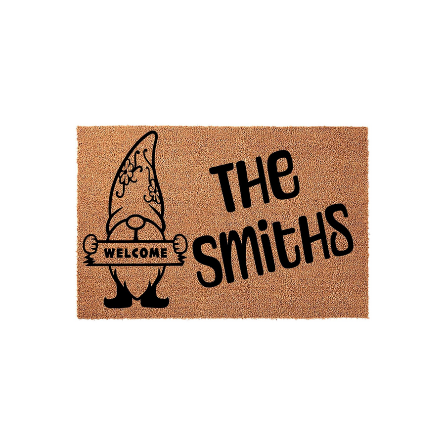 Personalized Gnome Welcome Doormat featuring a cute garden gnome illustration holding a sign that says Welcome, with space for a custom family name printed in bold black lettering on a natural tan coir fiber background for your