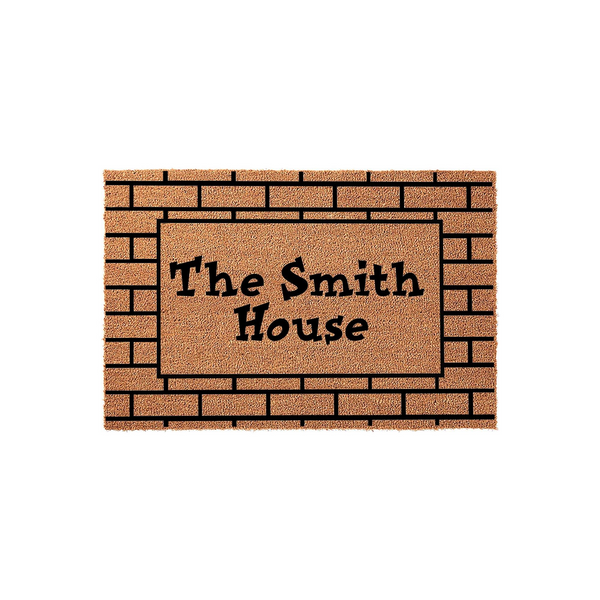 Personalized family name coir doormat featuring a rustic brick pattern border and bold black lettering that reads The Smith House, providing a durable and welcoming entrance mat for any front porch or home entryway decor.