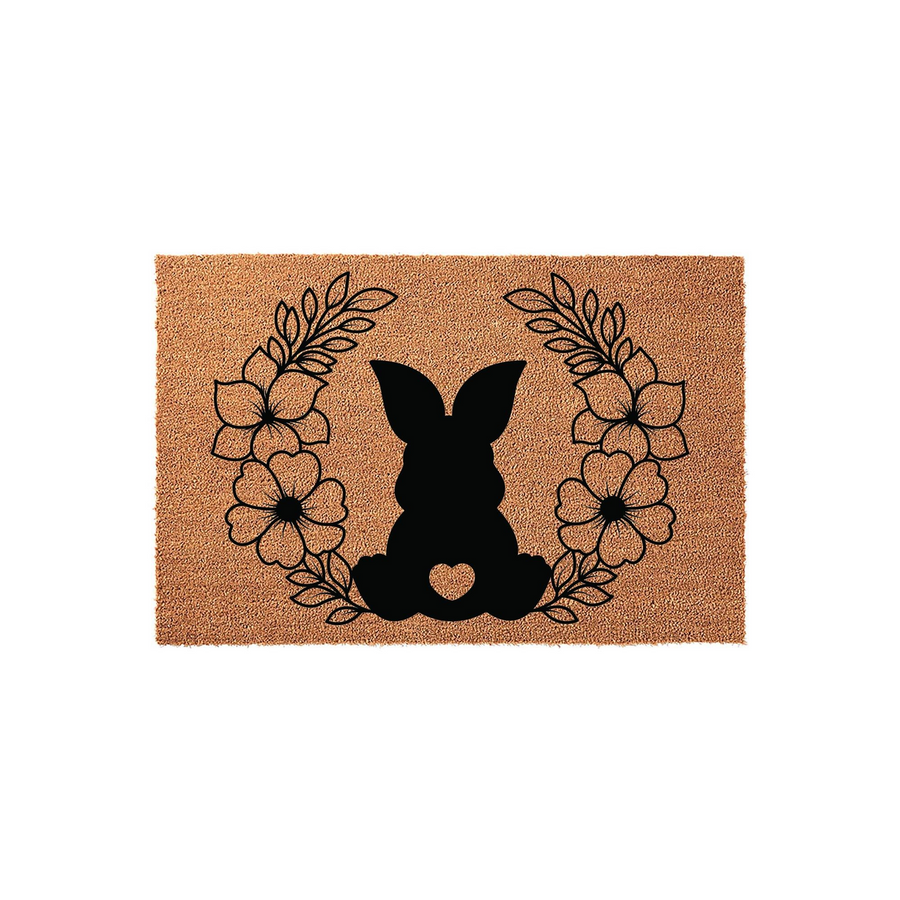 Easter Bunny Floral Coir Doormat featuring a black silhouette of a sitting rabbit with a heart cutout, surrounded by a delicate line-art wreath of flowers and leaves on a natural brown textured coconut fiber background for spring