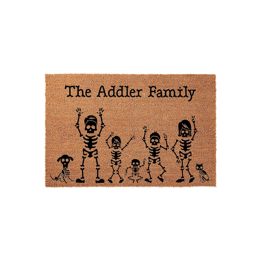 Personalized Halloween family doormat featuring a custom family name and a fun illustration of skeleton figures, including parents, children, and pets, printed on a natural tan coir fiber mat against a clean white background.