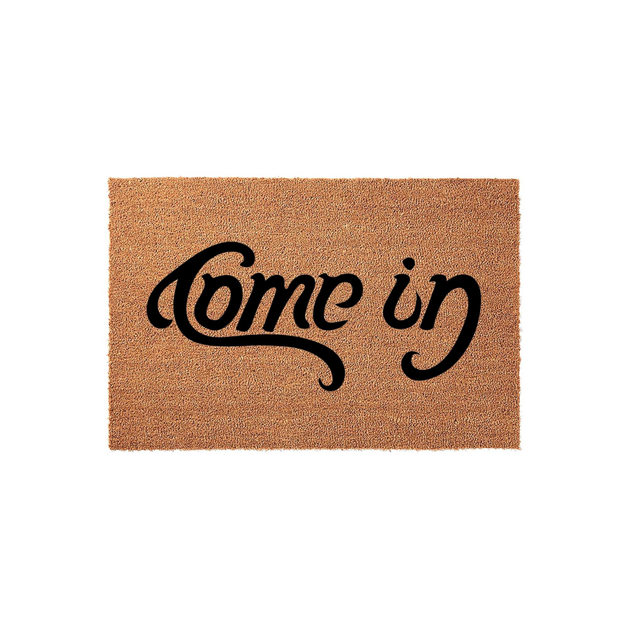 Come In coir doormat featuring a natural tan fiber texture and bold black script lettering centered on the rectangular mat, providing a welcoming and stylish entrance decor piece for your front porch or home entryway.