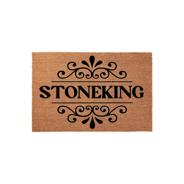 Personalized family name coir doormat featuring a classic black scrollwork design centered above and below the custom text, set against a natural tan coconut fiber background for a clean and welcoming front porch entryway