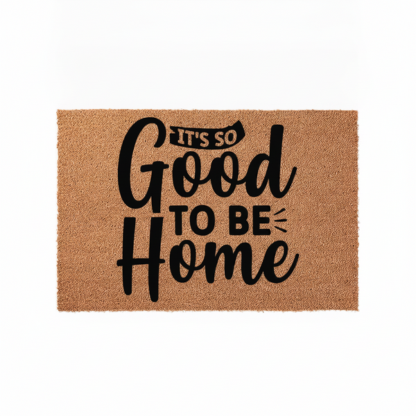 It's So Good To Be Home coir doormat featuring bold black typography printed on a natural brown coconut fiber mat, providing a welcoming and rustic aesthetic for your front porch entryway decor on a clean white background.