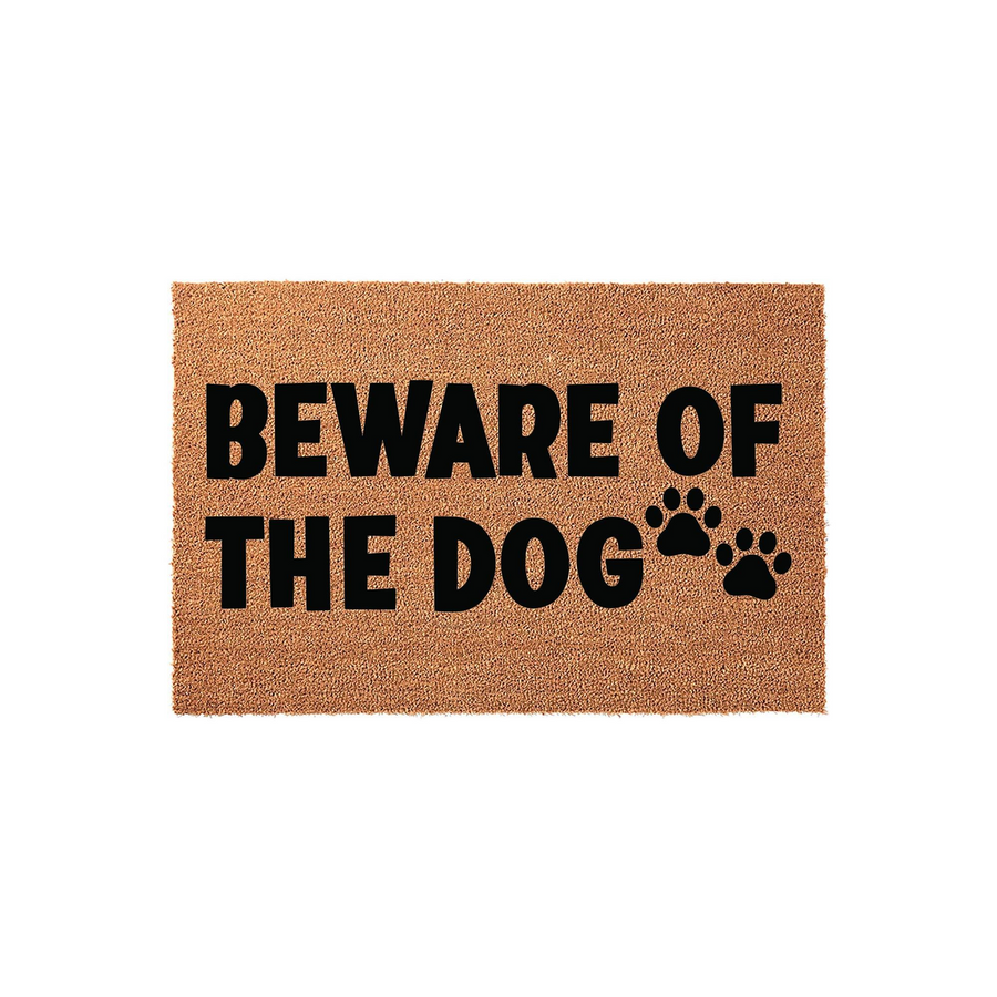 Beware of the Dog coir doormat featuring bold black text and cute paw print icons on a natural tan fiber background, creating a fun and functional entryway decor piece for any pet owner looking to add personality to their front