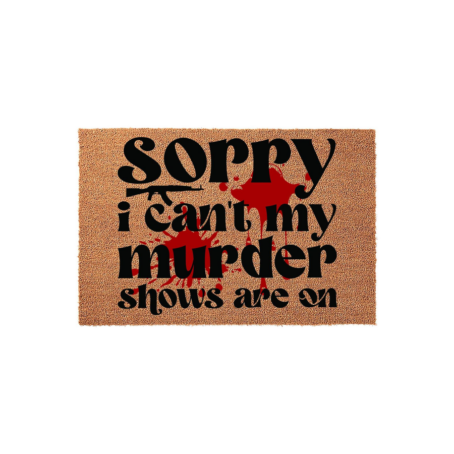 Funny Murder Shows Doormat featuring a natural coir texture with bold black text that reads Sorry I Can't My Murder Shows Are On, accented by a graphic red blood splatter design for a true crime fan home entrance decor piece.