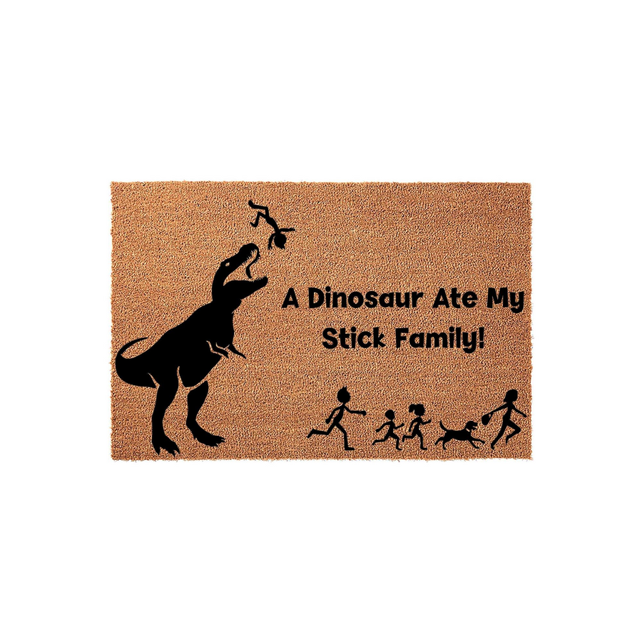 Funny Dinosaur Ate My Stick Family doormat featuring a large black T-Rex silhouette eating a stick figure, with the remaining family members and their dog running away on a natural brown coir fiber mat surface against a white