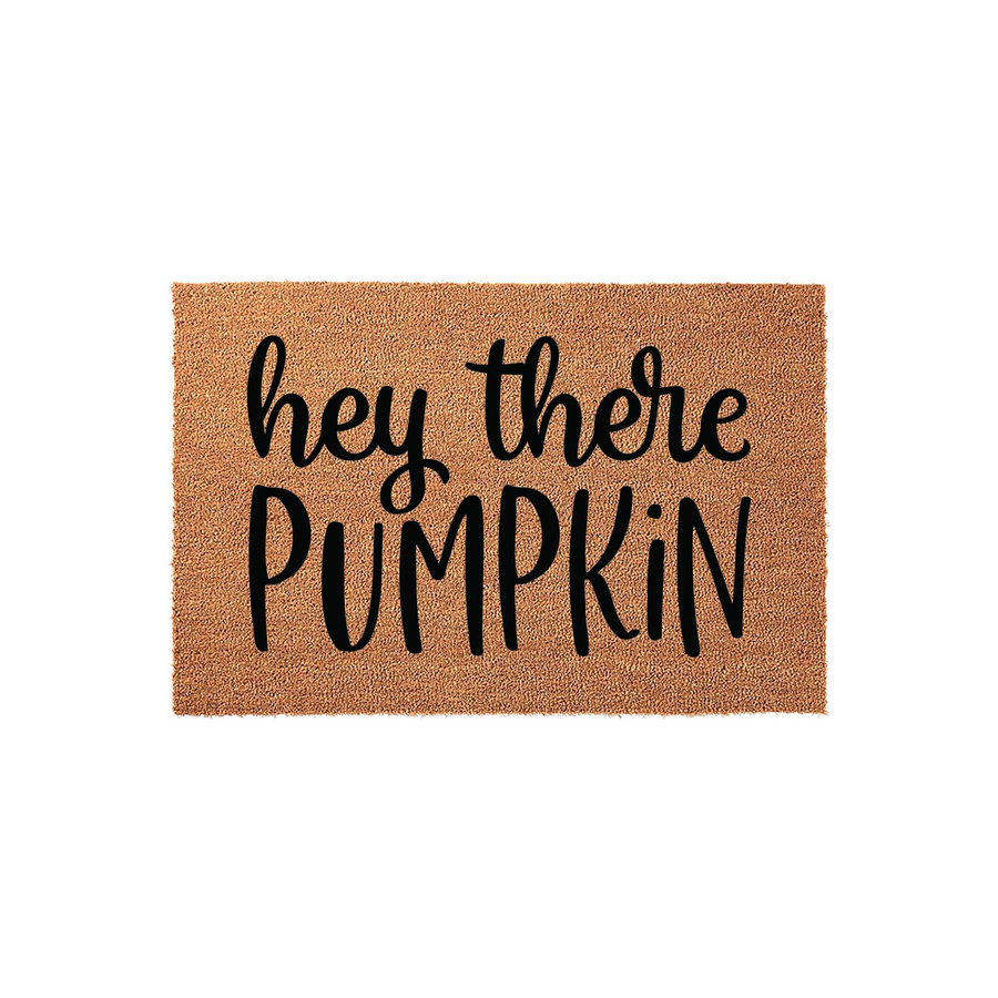 Hey There Pumpkin coir doormat featuring a natural brown fiber texture and bold black script lettering, making it a festive seasonal front porch decor piece for welcoming guests during the autumn and fall harvest holiday season.