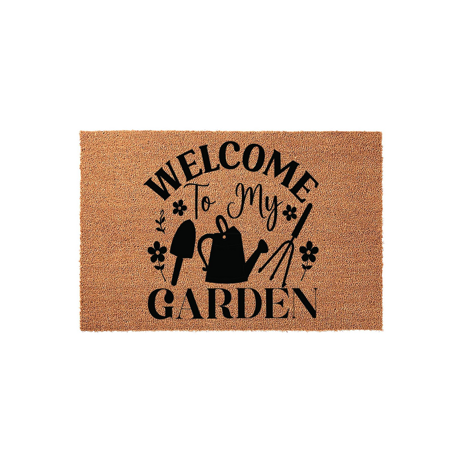 Welcome to My Garden coir doormat featuring a natural brown fiber texture and black printed graphics of a watering can, hand trowel, and garden rake, creating a charming outdoor entrance decor piece for any home gardener or plant