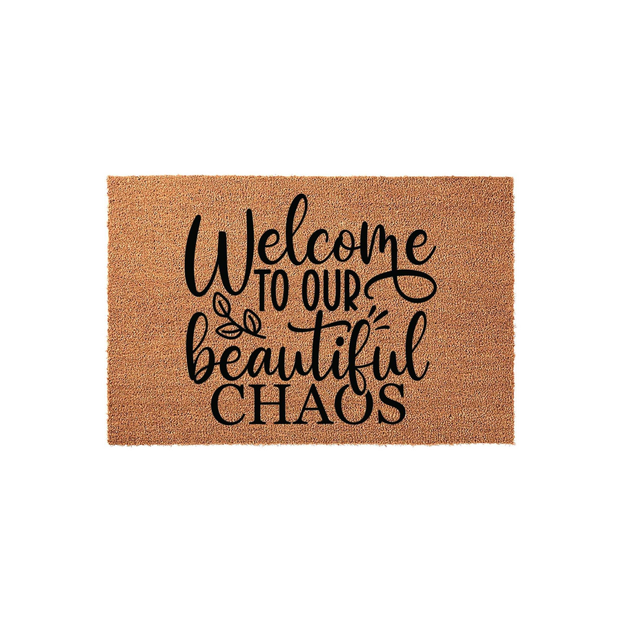 Welcome to Our Beautiful Chaos coir doormat featuring a natural tan fiber texture and bold black script lettering, providing a humorous and inviting entryway accent for any home front porch or indoor mudroom entrance area.