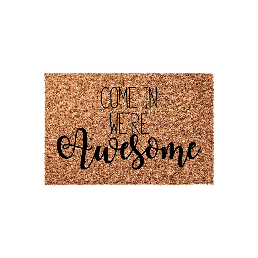 Come In We're Awesome coir doormat featuring a natural brown fiber texture and bold black typography, making it a fun and welcoming front porch decor piece for any home entrance that adds a touch of personality to your doorstep.