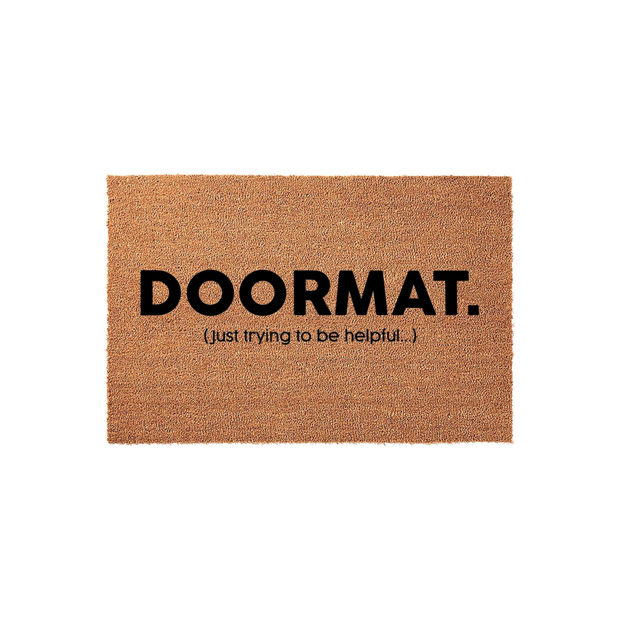 Funny Doormat with text that reads DOORMAT. (just trying to be helpful...) printed in bold black lettering on a natural brown coir fiber background, creating a humorous and welcoming entrance for any home front porch or entryway.