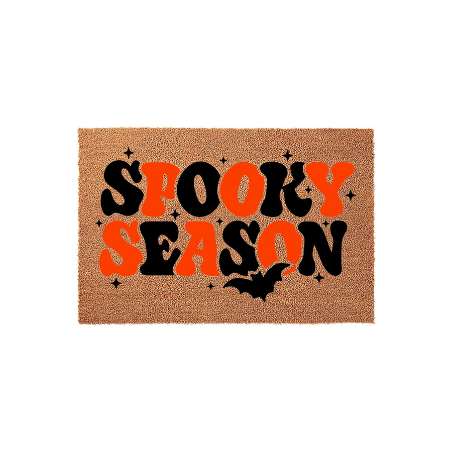 Spooky Season Halloween Coir Doormat featuring retro-style typography in alternating black and orange colors, accented with small stars and a black bat silhouette on a natural brown textured fiber background for a festive porch
