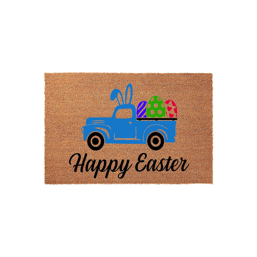 Happy Easter coir doormat featuring a blue vintage truck carrying colorful patterned eggs and bunny ears, set against a natural brown fiber background to add a festive spring touch to your front porch entryway decor for the