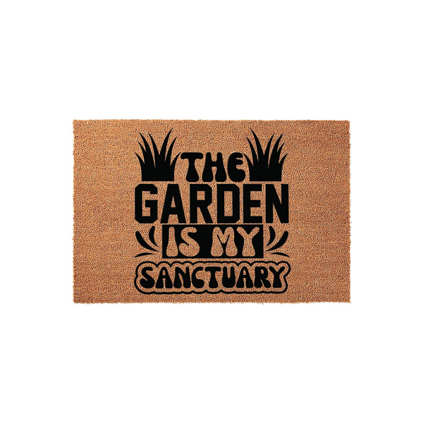 The Garden Is My Sanctuary coir doormat features a natural tan fiber texture with bold black lettering and stylized grass illustrations, making it a charming outdoor welcome mat for any home entrance or patio space.