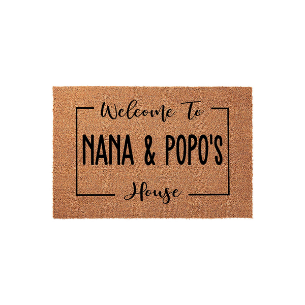 Personalized Nana and Popo's House coir doormat features a natural tan fiber texture with bold black text inside a rectangular frame, creating a welcoming entryway decor piece for a grandparent's home on a clean white background.