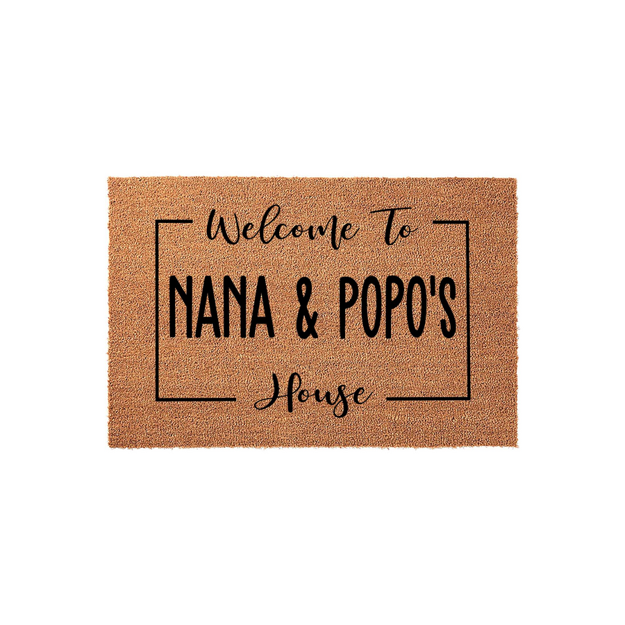 Personalized Nana and Popo's House coir doormat features a natural tan fiber texture with bold black text inside a rectangular frame, creating a welcoming entryway decor piece for a grandparent's home on a clean white background.
