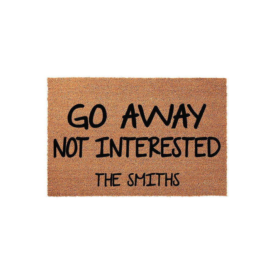 Personalized funny doormat featuring the text Go Away Not Interested with a customizable family name printed in bold black lettering on a natural brown coir fiber mat, perfect for a humorous front porch entrance decor statement.