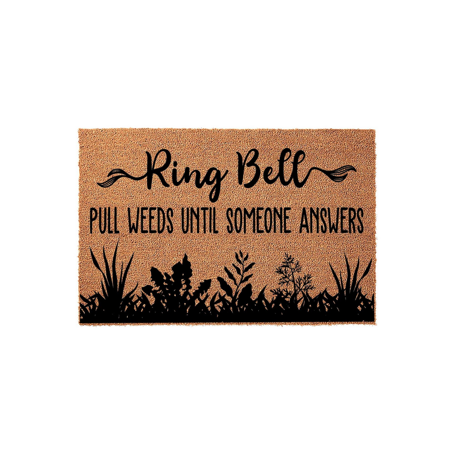 Funny Garden Welcome Doormat featuring a natural coir texture with black text that reads Ring Bell and Pull Weeds Until Someone Answers, accented by a silhouette of various weeds and wild plants along the bottom edge of the mat.