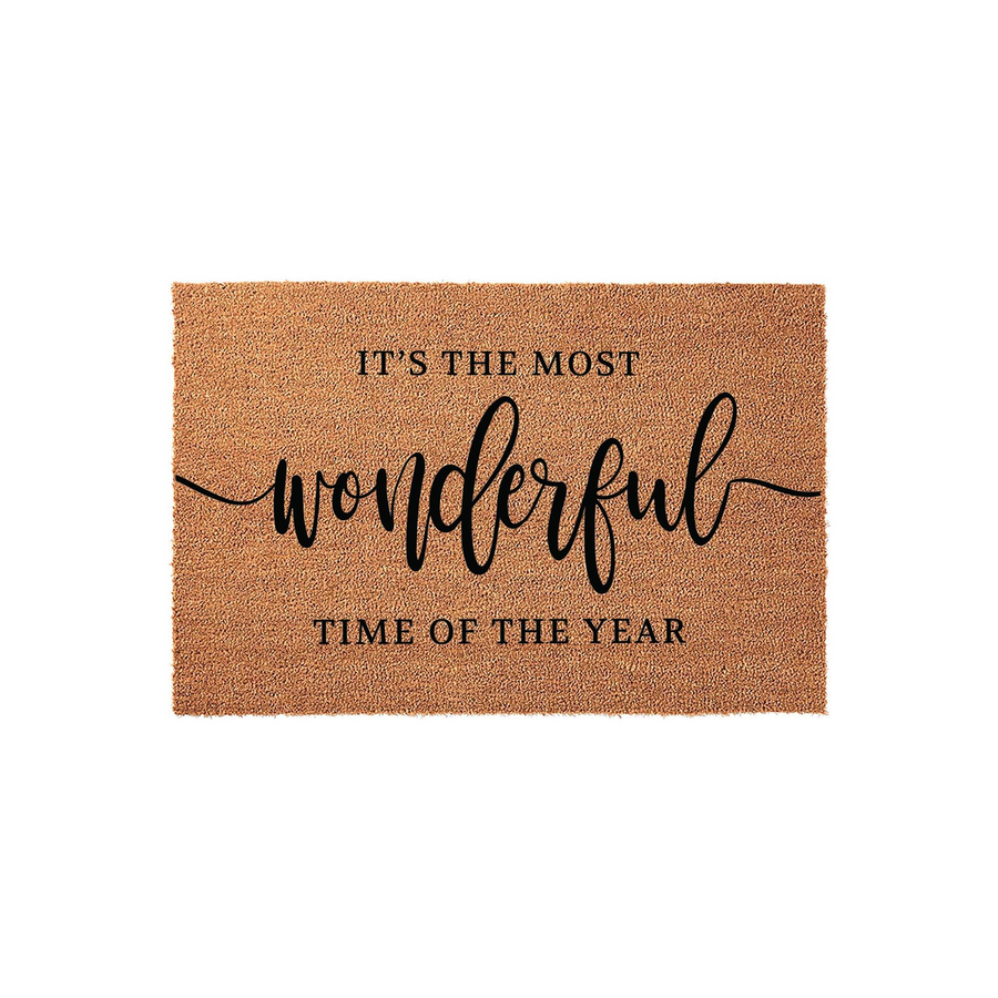 Christmas coir doormat featuring the festive phrase It is the most wonderful time of the year in elegant black script and block lettering, set against a natural brown textured fiber background for a classic holiday entryway decor.